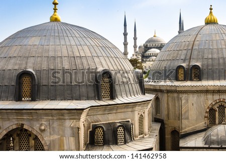 Blue Mosque or Sultan Ahmed Mosque viewed trough the window of Hagia Sophia, former Orthodox patriarchal basilica (church), later a mosque, and now a museum in Istanbul, Turkey.