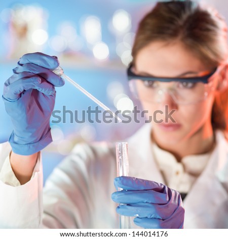 Similar – Image, Stock Photo Young scientist pipetting solution.