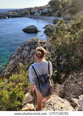 Similar – Image, Stock Photo Young active feamle tourist wearing small backpack walking on coastal path among pine trees looking for remote cove to swim alone in peace on seaside in Croatia. Travel and adventure concept.