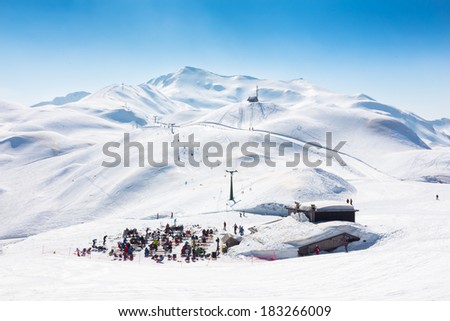 Skiers on ski slopes in  Alp mountains, Triglav natural park, Vogel, Bohinj, Slovenia.