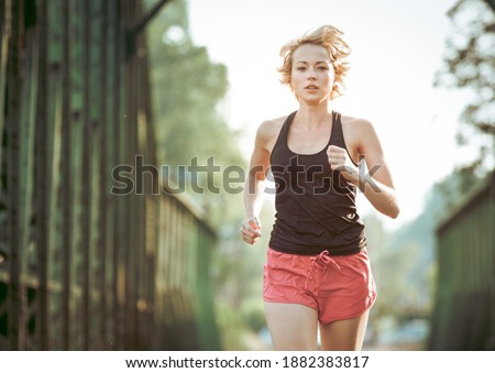 Similar – Image, Stock Photo Athlete running on railaway bridge training for marathon and fitness. Healthy sporty caucasian woman exercising in urban environment before going to work. Active urban lifestyle