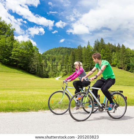 Similar – Image, Stock Photo Young spoty active cople biking in nature. Active lifestyle. Activities and recreation outdoors.