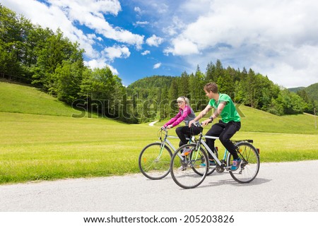 Similar – Image, Stock Photo Young spoty active cople biking in nature. Active lifestyle. Activities and recreation outdoors.