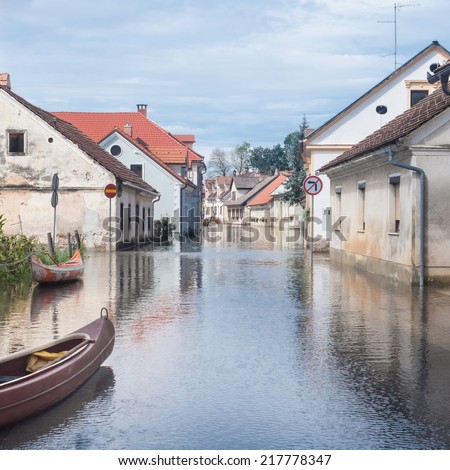 Rural village houses in floodwater. Road with the river overflown with the residents in their homes. River Krka floods and flooding the streets. Natural disaster in Kostanjevica, Slovenia.