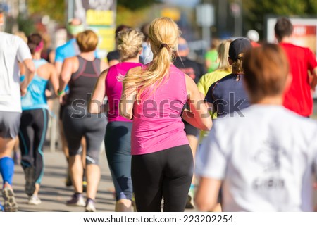 Group of active people running in the city. Healthy lifestyle. Weight Loss. Urban marathon run.