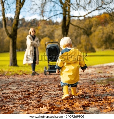 Similar – Image, Stock Photo Stroller in the rain with umbrella