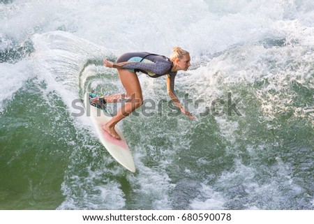 Similar – Image, Stock Photo Atractive sporty girl surfing on famous artificial river wave in Englischer garten, Munich, Germany.