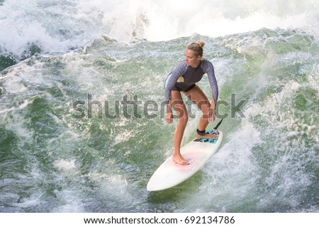 Similar – Image, Stock Photo Atractive sporty girl surfing on famous artificial river wave in Englischer garten, Munich, Germany.