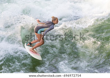 Similar – Image, Stock Photo Atractive sporty girl surfing on famous artificial river wave in Englischer garten, Munich, Germany.