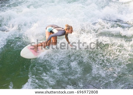 Similar – Image, Stock Photo Atractive sporty girl surfing on famous artificial river wave in Englischer garten, Munich, Germany.