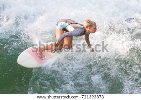 Image, Stock Photo Atractive sporty girl surfing on famous artificial river wave in Englischer garten, Munich, Germany.