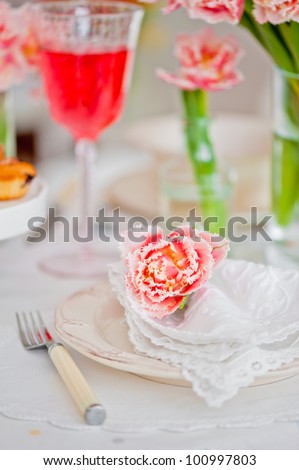Wedding place setting and pink tulips