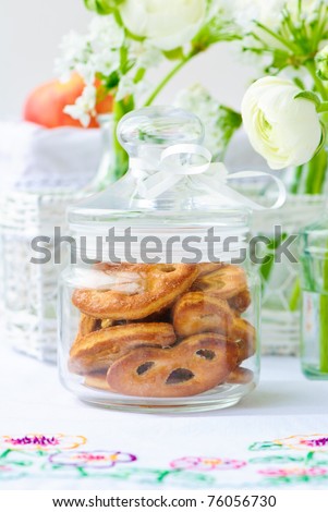 Cookies into a glass jar and a fresh bouquets of white ranunculus