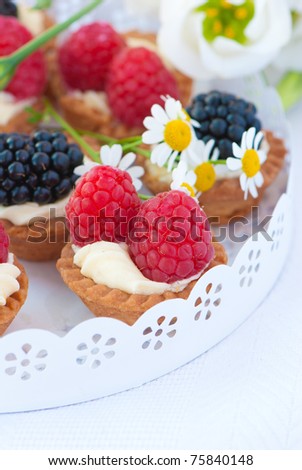 delicious fresh berry cakes and spring flowers