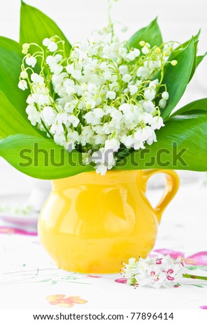 Lily of the valley in a yellow milk jug