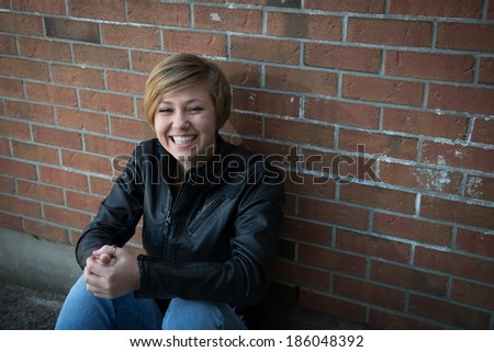 Happy teenage girl hangs out outside school