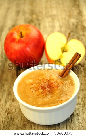 Healthy organic homemade apple sauce on wood background