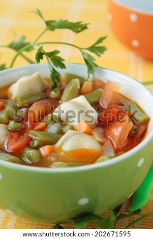 Soup with meat dumplings, green beans, peas, tomatoes, peppers