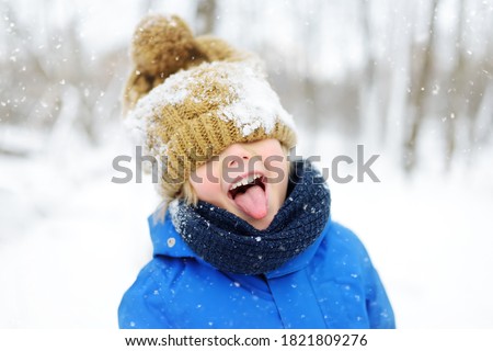 Similar – Image, Stock Photo Cheerful child during walk in the forest on a sunny autumn day. Preschooler boy is having fun while walking through the autumn forest. Family time on nature.