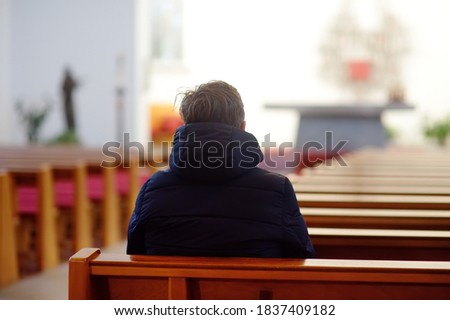 Religious middle age man praying and meditating in catholic church. Person begging for forgiveness and blessing from God. Catholicism is Christianity religion. Photo stock © 