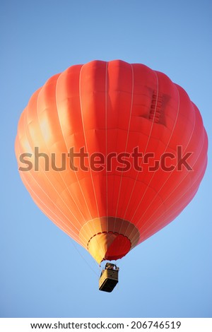 Red hot air balloon on blue background