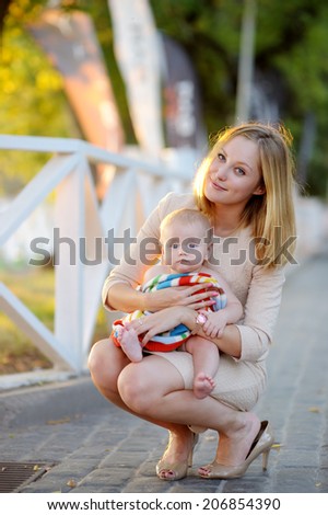 Young mother with her little baby outdoors
