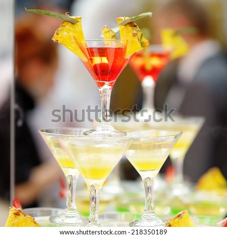 Delicious red and yellow cocktail tower with fresh pineapple (cocktail party)