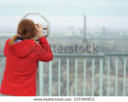 Young beautiful woman on observation deck in Montparnasse building in Paris, France