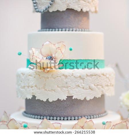 Delicious white and grey wedding cake decorated with flowers