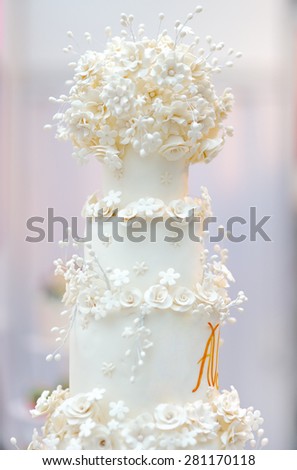 Delicious white wedding cake decorated with cream flowers