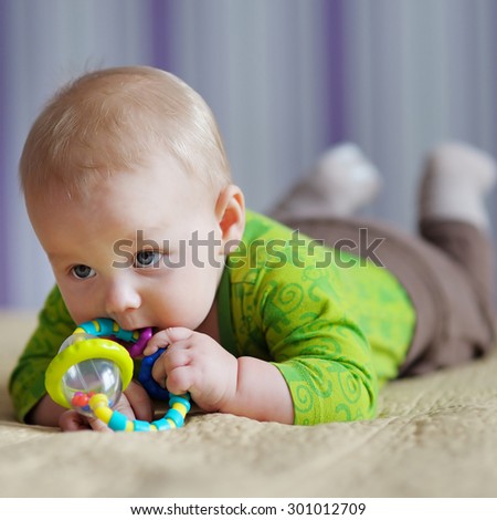 Six month old baby play with bright toy
