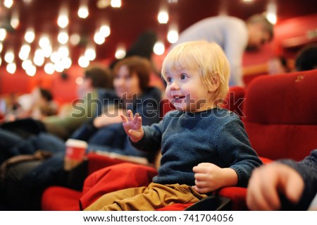 Cute toddler boy watching cartoon movie in the cinema. Leisure/entertainment for family with kids. Foto stock © 