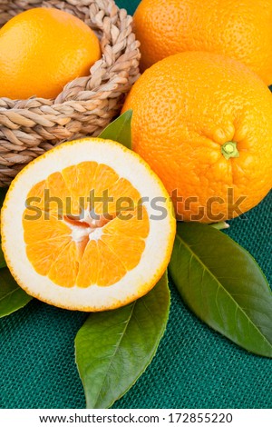 Orange fruits over green canvas fabric