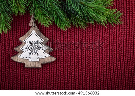 Christmas Red Knitted Background With Christmas Tree Decoration In