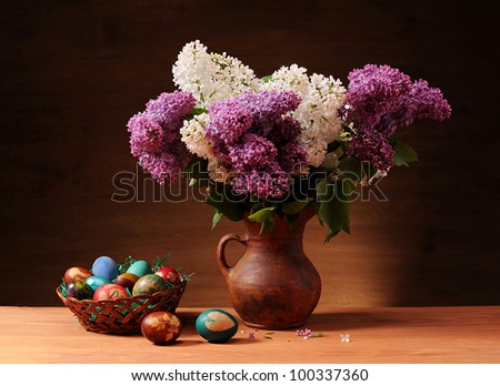 Lilac in vase and colored Easter eggs