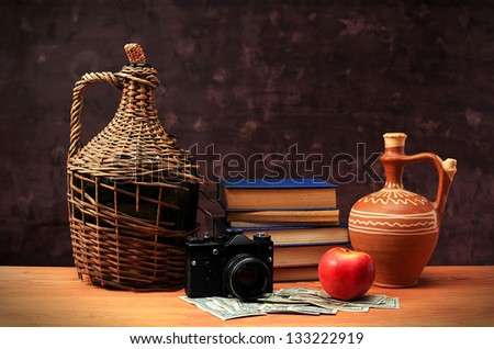 Old things, books and apple on the table