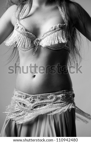 young beautiful dancer posing on a studio background/Art image of belly dancer