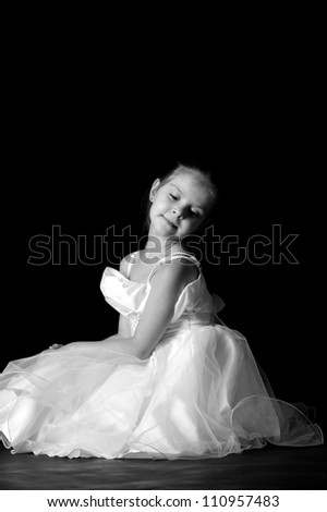 Little girl express her feelings over dance/Black and White image of dancer over dark background