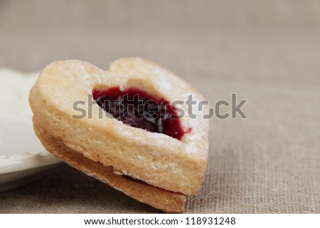 heart-shaped biscuit with sweet jam inside on tea time