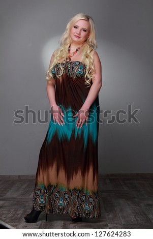 Beautiful blond long hair plus-size woman in long dress