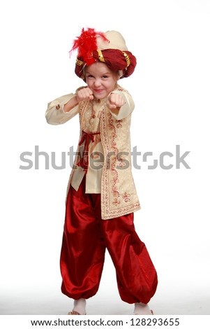 Studio image of emotion and funny girl in oriental costume over light background on Holiday theme