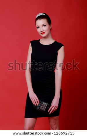 Young caucasian woman on Fashion theme/Beautiful figure of a girl in black little dress