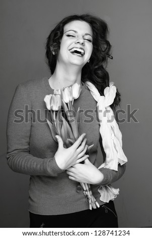 Happy young girl with a bouquet of spring flowers/Portrait of a girl with spring flowers in retro style