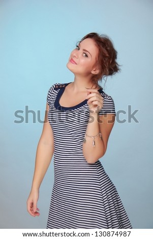 Attractive young woman in a pretty dress flirting