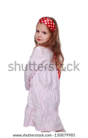 Little girl with bright red lips in fancy dress on Holiday