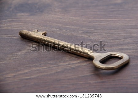 Ancient metal key on wooden background