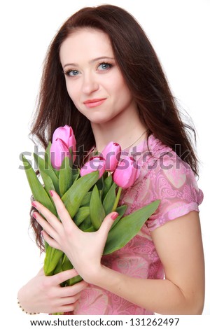 Pretty girl in pink blouse holding beautiful pink flowers
