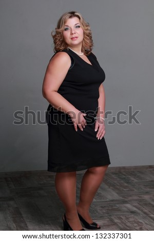 Fat woman with beautiful hair and makeup/Female portrait of european lovely woman wearing black elegant dress