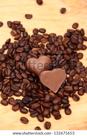 Lots of coffee sweets in shape of heart and coffee beans spilling