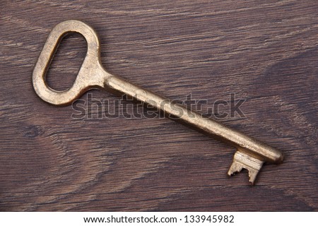 Key to the old pattern/Key from an old case on a wooden surface